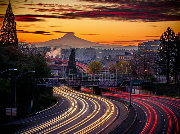 The dawn awakens in a blaze of glory while commuters stream to their cubicles.