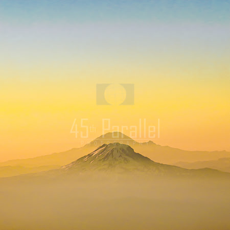 Mt. Adams and Mt. Rainier glow under a beautiful Pacific Northwest sunset