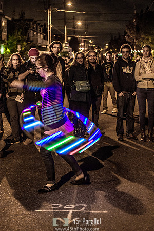 Street dancer with a glowing hula hoop.