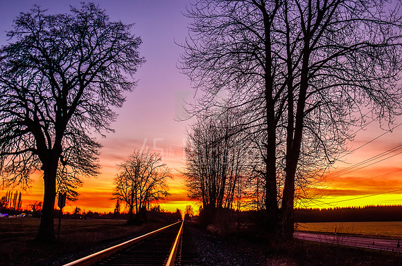 A Winter Sunset on a Railroad Track